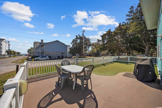 view of patio with outdoor dining space, a fenced backyard, and a grill