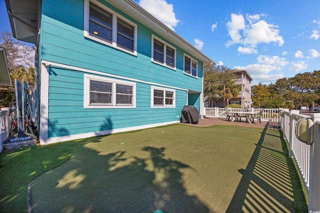 rear view of house featuring fence