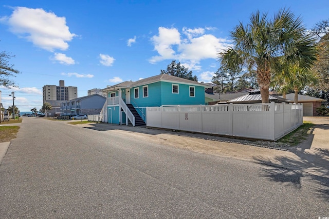 view of front of home featuring fence