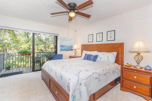 bedroom featuring a textured ceiling, a ceiling fan, light colored carpet, and access to exterior