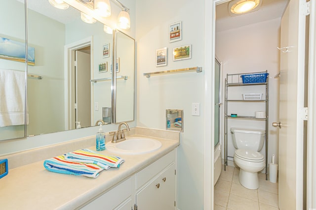 full bathroom featuring shower / bath combination with glass door, vanity, toilet, and tile patterned floors