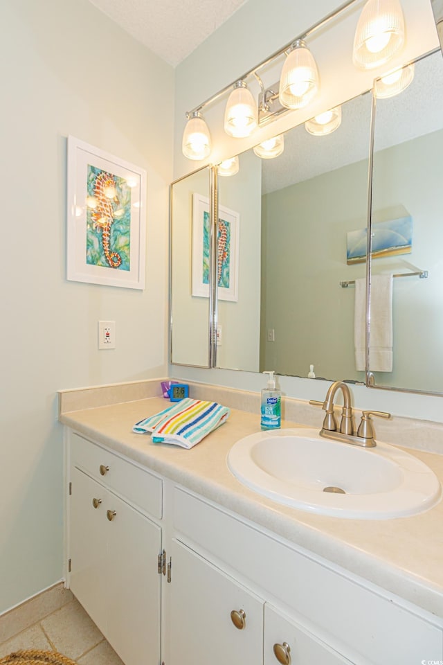 bathroom featuring a textured ceiling, vanity, and tile patterned floors