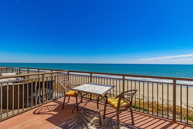 balcony featuring a water view and a view of the beach