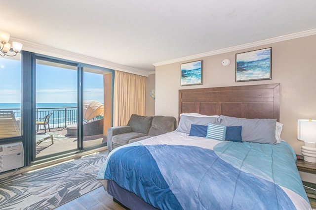 bedroom featuring a notable chandelier, crown molding, a water view, wood finished floors, and access to outside