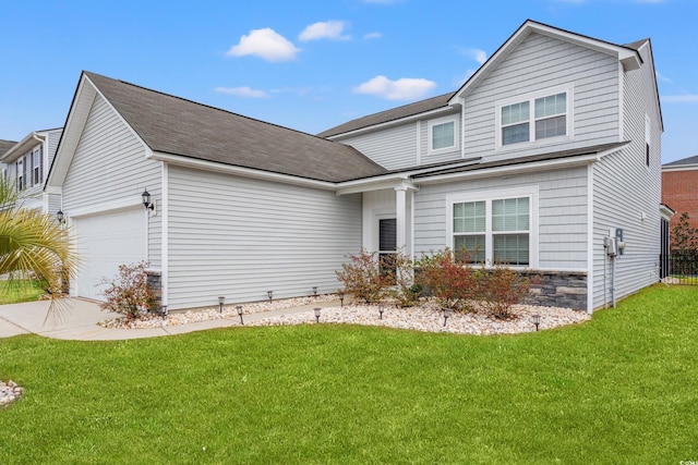 traditional-style house featuring an attached garage, driveway, and a front lawn