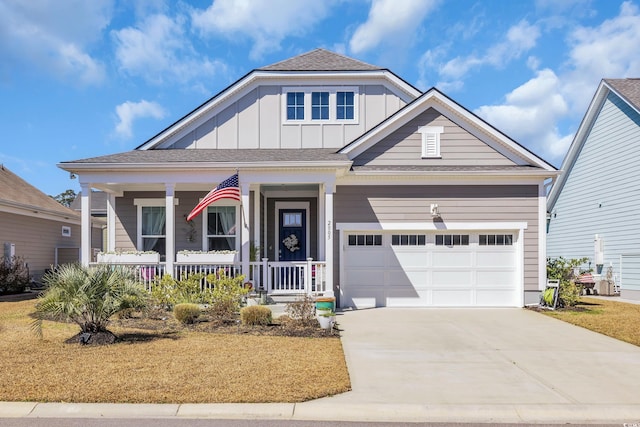 view of front of house with board and batten siding, concrete driveway, a porch, and a garage