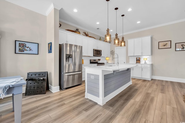 kitchen with decorative backsplash, stainless steel appliances, light countertops, white cabinetry, and a sink