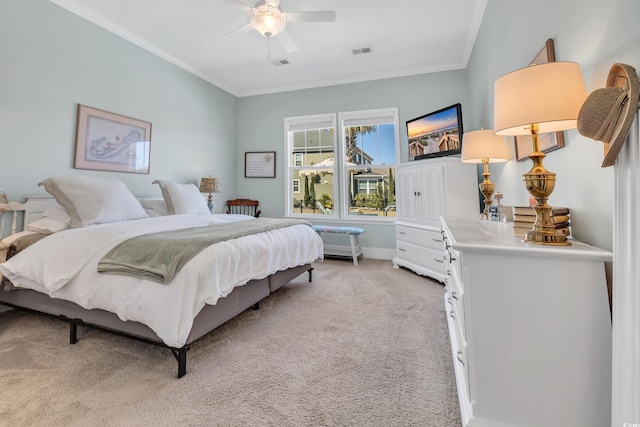 bedroom featuring ornamental molding, a ceiling fan, visible vents, and light colored carpet