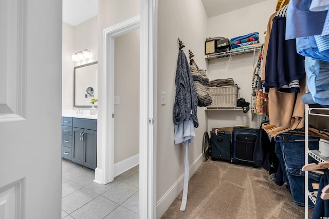 walk in closet with light tile patterned flooring