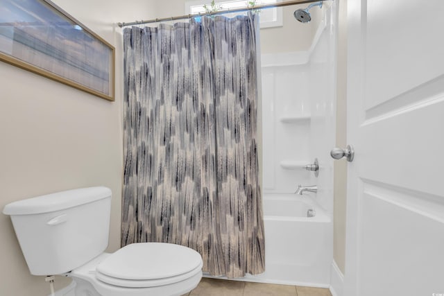 full bath with shower / bath combo, tile patterned flooring, and toilet