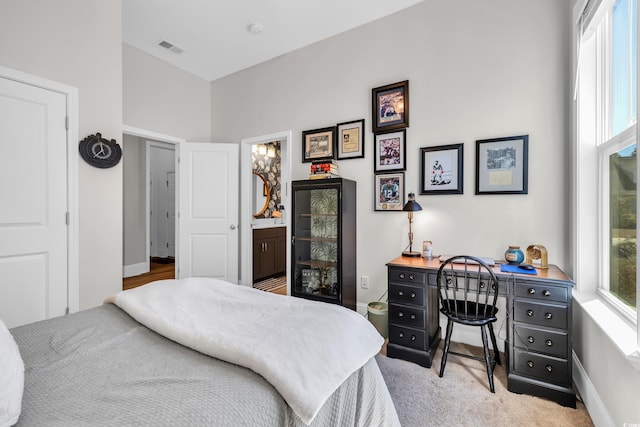 bedroom with multiple windows, visible vents, and baseboards