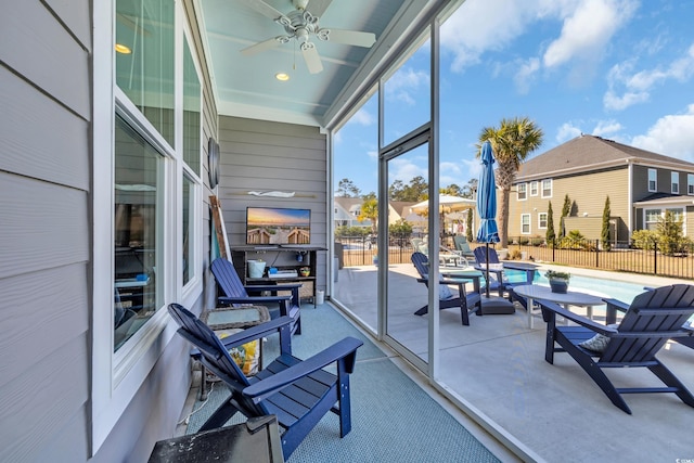 sunroom / solarium featuring a ceiling fan