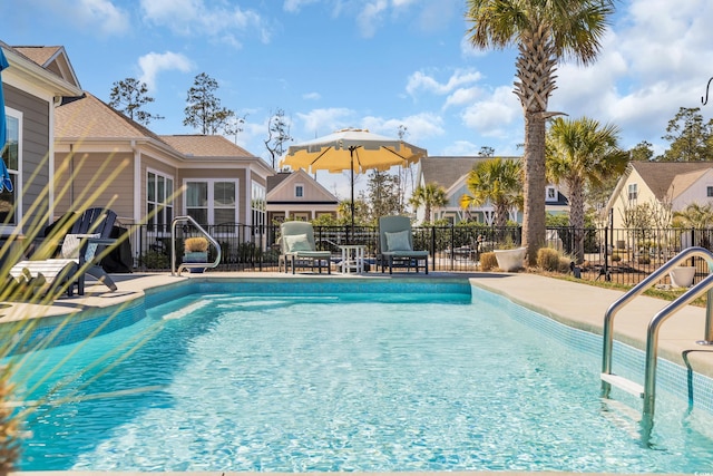 pool featuring fence and a patio