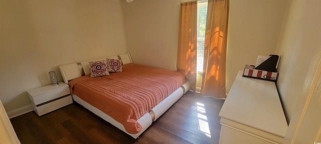 bedroom featuring baseboards and wood finished floors