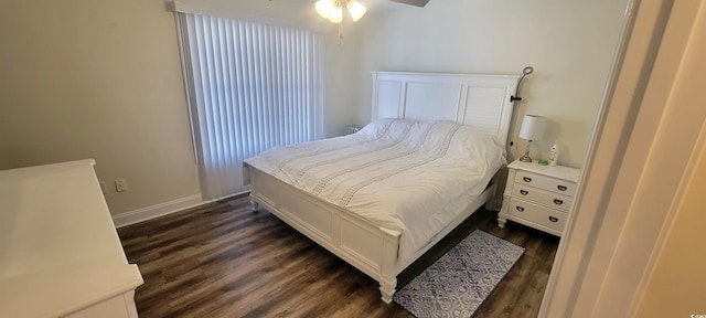 bedroom featuring dark wood-style flooring and baseboards