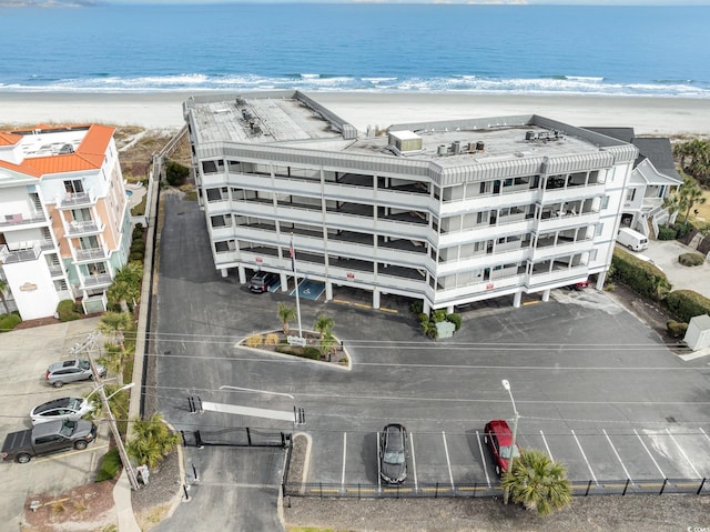 drone / aerial view with a water view and a beach view