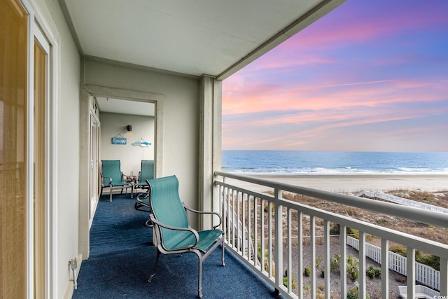 balcony featuring a water view and a view of the beach