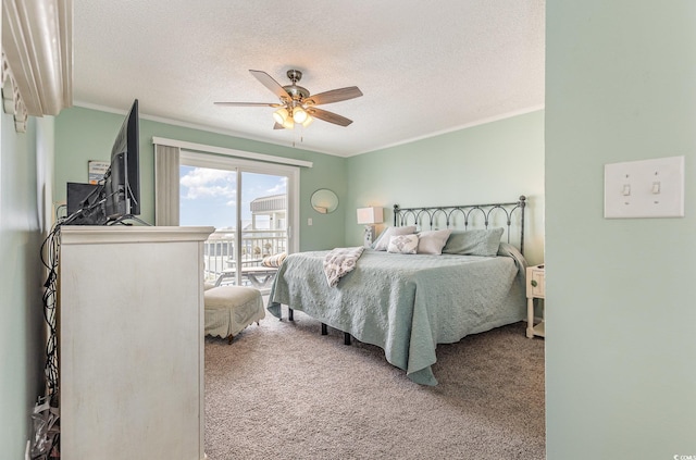 carpeted bedroom with a textured ceiling, access to outside, ceiling fan, and crown molding