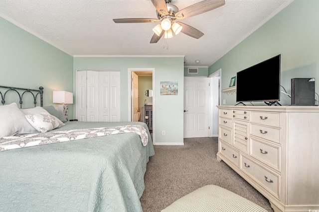 bedroom featuring ornamental molding, a closet, carpet flooring, and a textured ceiling