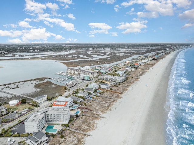 birds eye view of property featuring a view of the beach and a water view