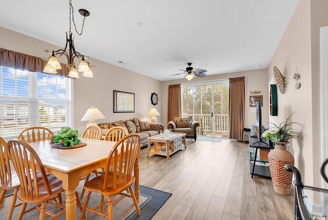 dining space with a ceiling fan and light wood-style flooring