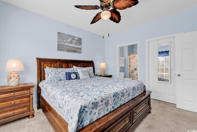 bedroom with connected bathroom, a ceiling fan, and light colored carpet