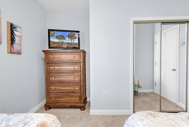 bedroom featuring carpet, baseboards, and a closet