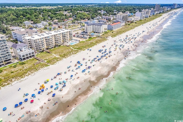 aerial view featuring a water view, a city view, and a view of the beach