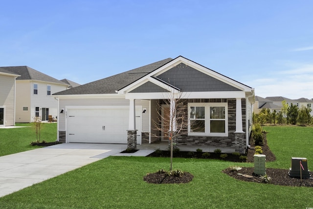 4295 Falls Oaks St, Myrtle Beach, SC 29579 - view of front facade featuring stone siding, driveway, a front lawn, and an attached garage