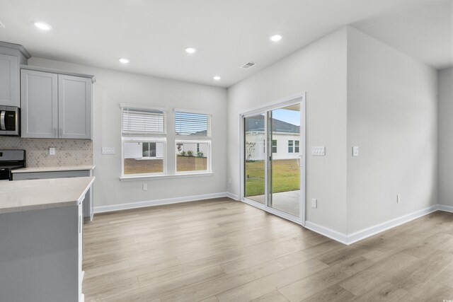 4295 Falls Oaks St, Myrtle Beach, SC 29579 - kitchen with light countertops, decorative backsplash, visible vents, light wood-style flooring, and appliances with stainless steel finishes