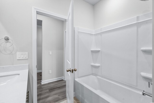 4295 Falls Oaks St, Myrtle Beach, SC 29579 - bathroom featuring baseboards, tub / shower combination, wood finished floors, and a sink