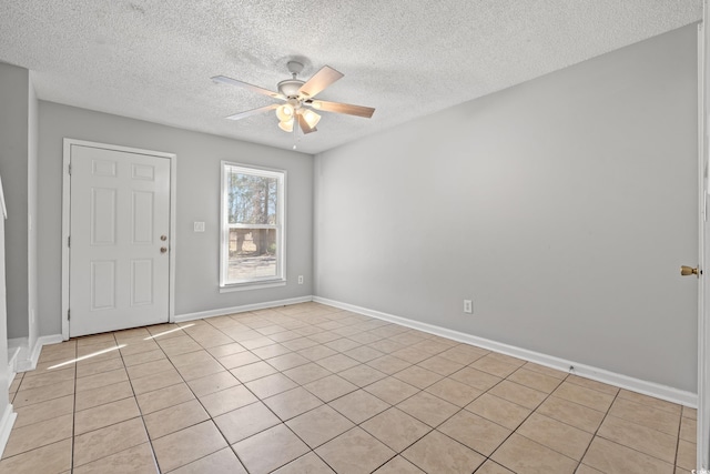 entrance foyer with a textured ceiling, baseboards, and ceiling fan