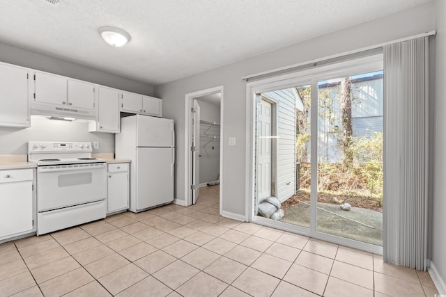 kitchen featuring white appliances, white cabinets, light countertops, and under cabinet range hood