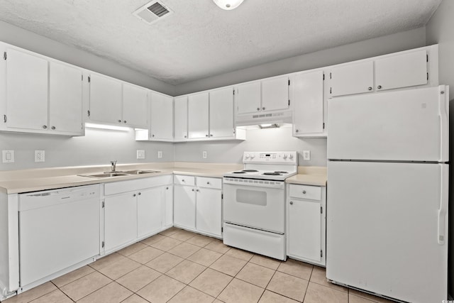 kitchen with white appliances, white cabinets, visible vents, and under cabinet range hood