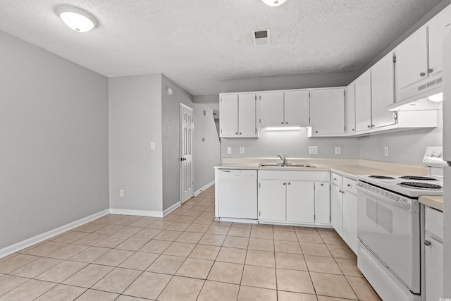 kitchen featuring under cabinet range hood, light countertops, light tile patterned floors, white appliances, and a sink