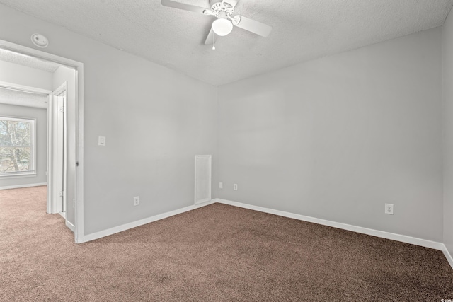 unfurnished room featuring baseboards, a textured ceiling, and carpet flooring