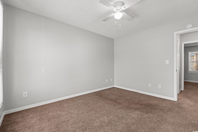 spare room featuring carpet flooring, a ceiling fan, baseboards, and a textured ceiling