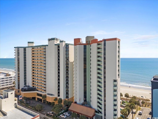 view of property featuring a view of the beach and a water view