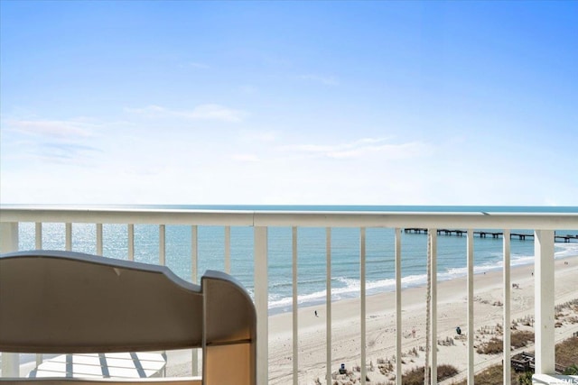 balcony with a water view and a beach view