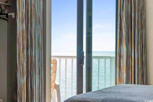 unfurnished bedroom featuring a water view