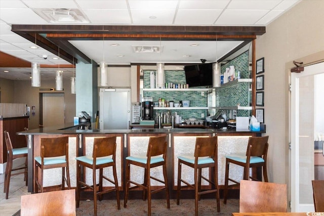 kitchen featuring a paneled ceiling and visible vents