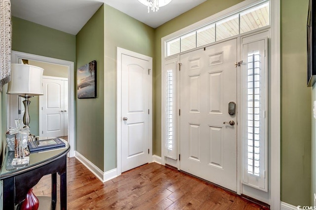 foyer entrance featuring wood finished floors and baseboards