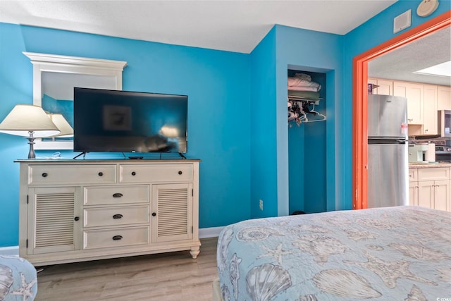 201 S Ocean Blvd Unit 217, Myrtle Beach, SC 29577 - bedroom with freestanding refrigerator and wood finished floors