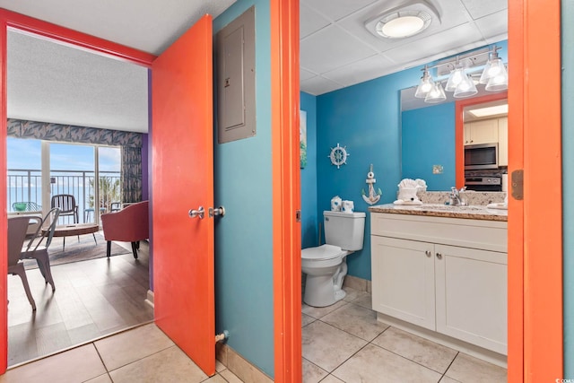 201 S Ocean Blvd Unit 217, Myrtle Beach, SC 29577 - bathroom featuring toilet, tile patterned floors, vanity, a paneled ceiling, and baseboards