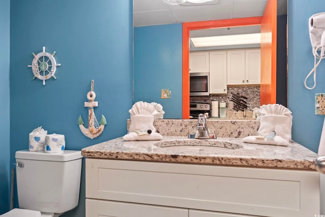 201 S Ocean Blvd Unit 217, Myrtle Beach, SC 29577 - bathroom featuring vanity, toilet, and backsplash