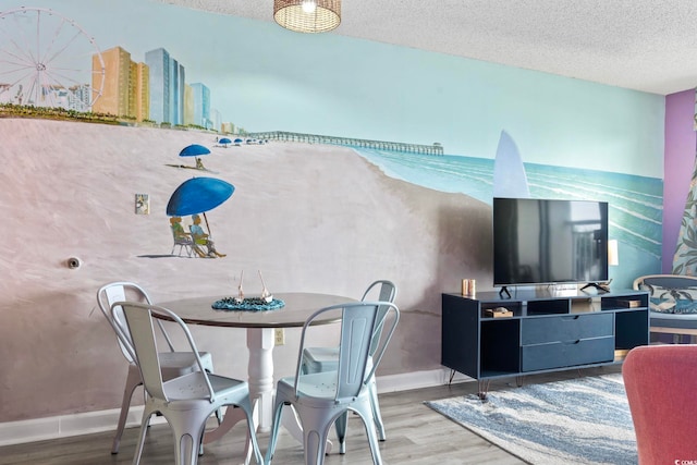 201 S Ocean Blvd Unit 217, Myrtle Beach, SC 29577 - dining space featuring wood finished floors, baseboards, and a textured ceiling