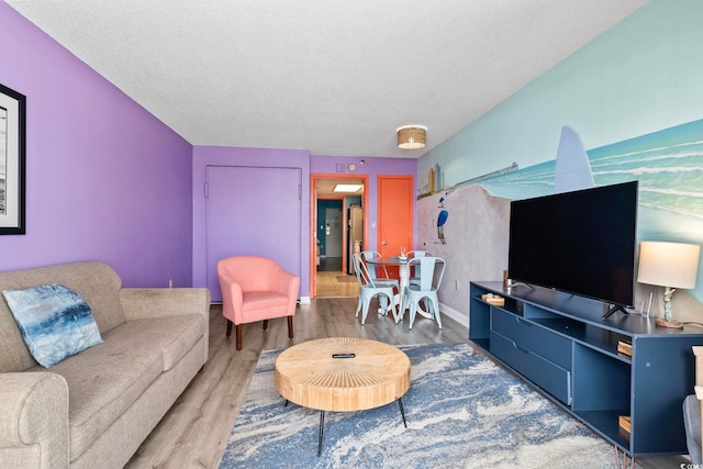 201 S Ocean Blvd Unit 217, Myrtle Beach, SC 29577 - living room featuring wood finished floors and a textured ceiling