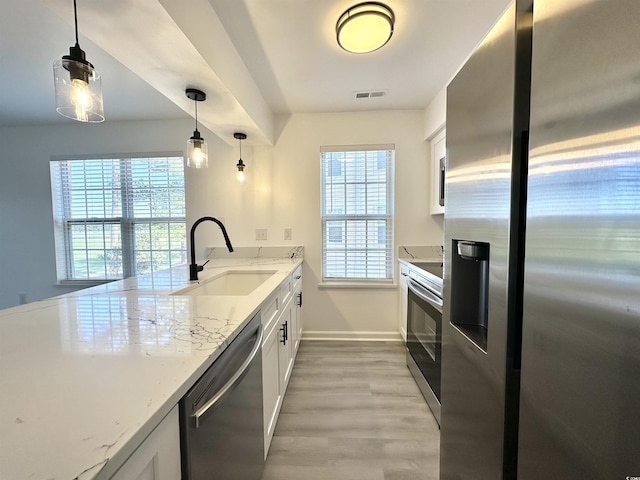 5000 Windsor Green Way Unit 204, Myrtle Beach, SC 29579 - kitchen with stainless steel appliances, a sink, light wood-type flooring, white cabinetry, and light stone countertops