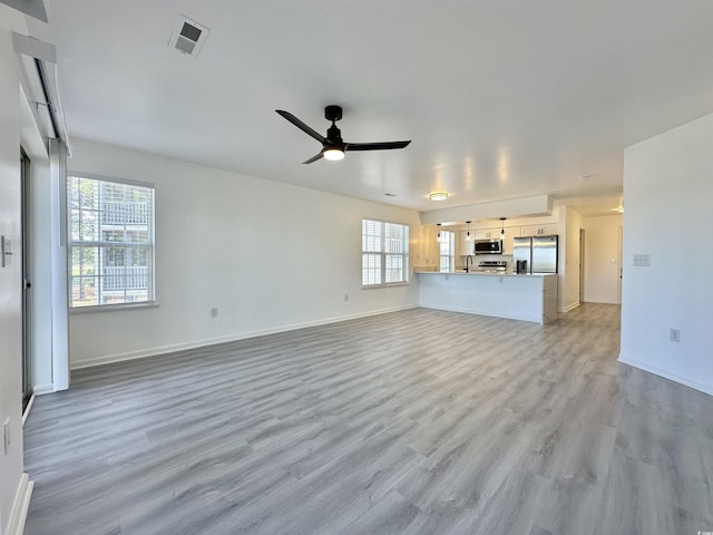 5000 Windsor Green Way Unit 204, Myrtle Beach, SC 29579 - unfurnished living room with healthy amount of natural light, ceiling fan, light wood-style floors, and baseboards