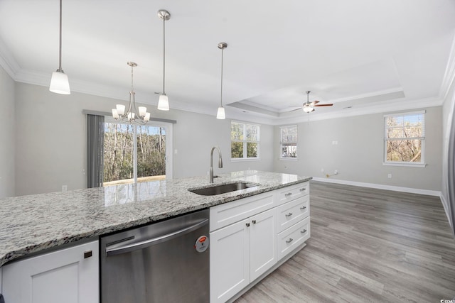 kitchen featuring a tray ceiling, crown molding, light wood-style flooring, a sink, and dishwasher